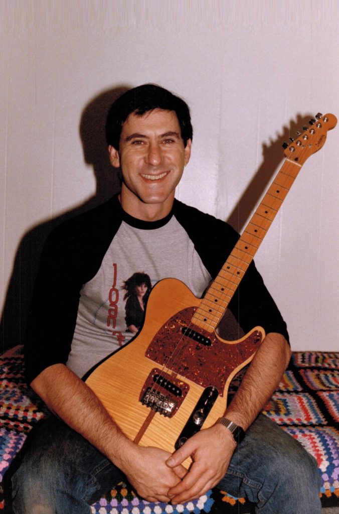 Roger Sadowsky holding one of the "Ejacucaster" guitars he built for Prince. 